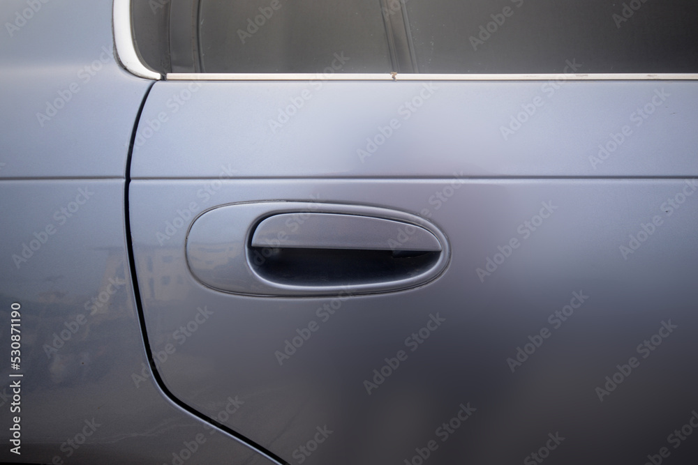 Handle of a silver car door Handle of a silver car door