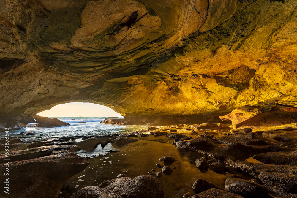 An interior view taken from the back of Waenhuiskrans sea-cave towards the mouth of the cave and the sea. Arniston. Overberg.  Western Cape. South Africa