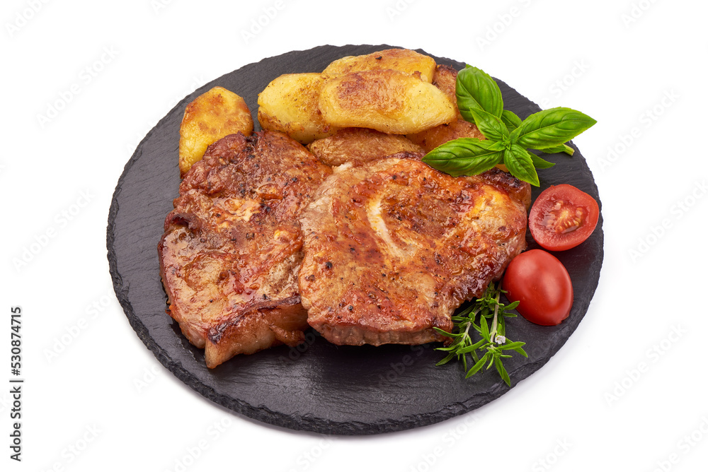 Roasted juicy pork steak with baked potatoes, BBQ dishes, isolated on white background.
