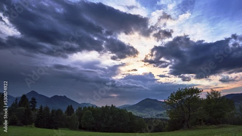 Lovely Rrural mountain landscape in summer in slovakia . Clouds break up after a storm at dusk photo