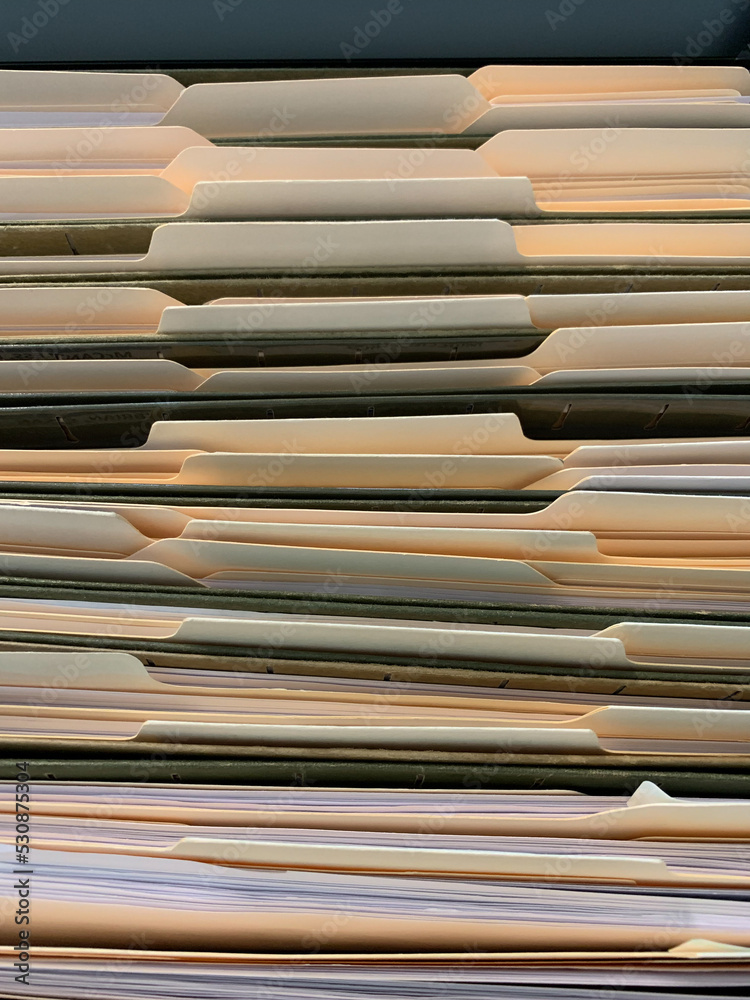 View of file folders with documents in filing cabinet. View of file folders with documents in filing cabinet.