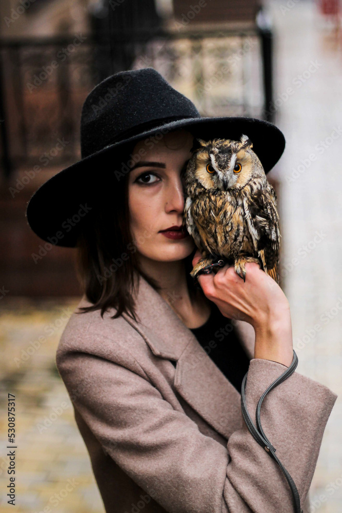 very beautiful girl in a hat with an owl