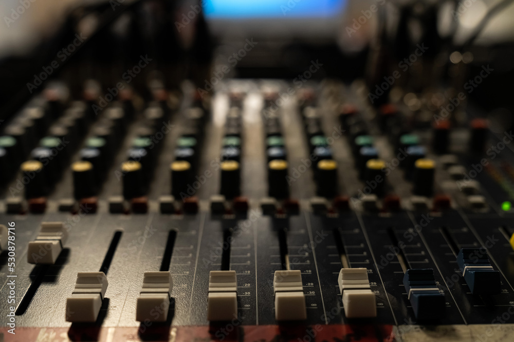 controls on an audio mixer, Sound mixer. Professional audio mixing console with lights, buttons, faders and sliders.