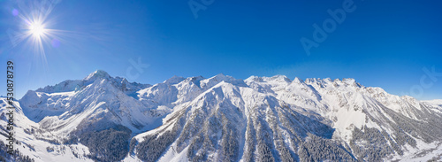 Panorame of winter landscape in mountains at sunny day © pridannikov