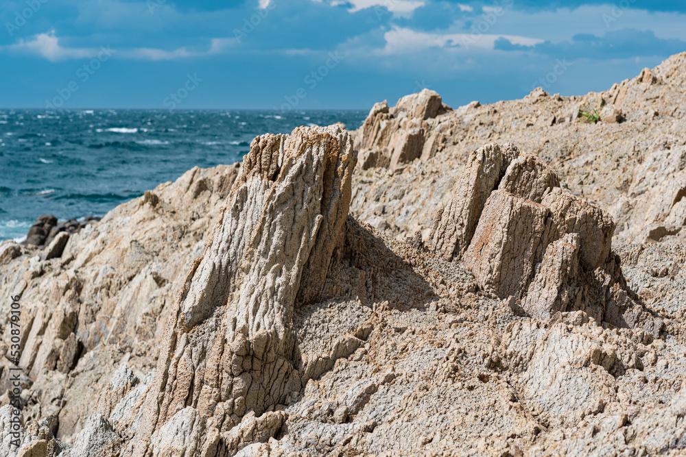 rocky seashore formed by columnar basalt against the sea, coastal landscape of the Kuril Islands