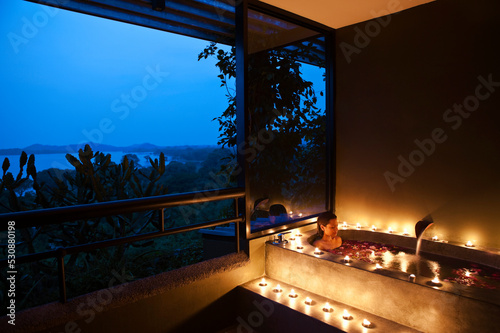 Woman in Floral Bath at Dusk at a Spa. Dambulla, Sri Lanka.