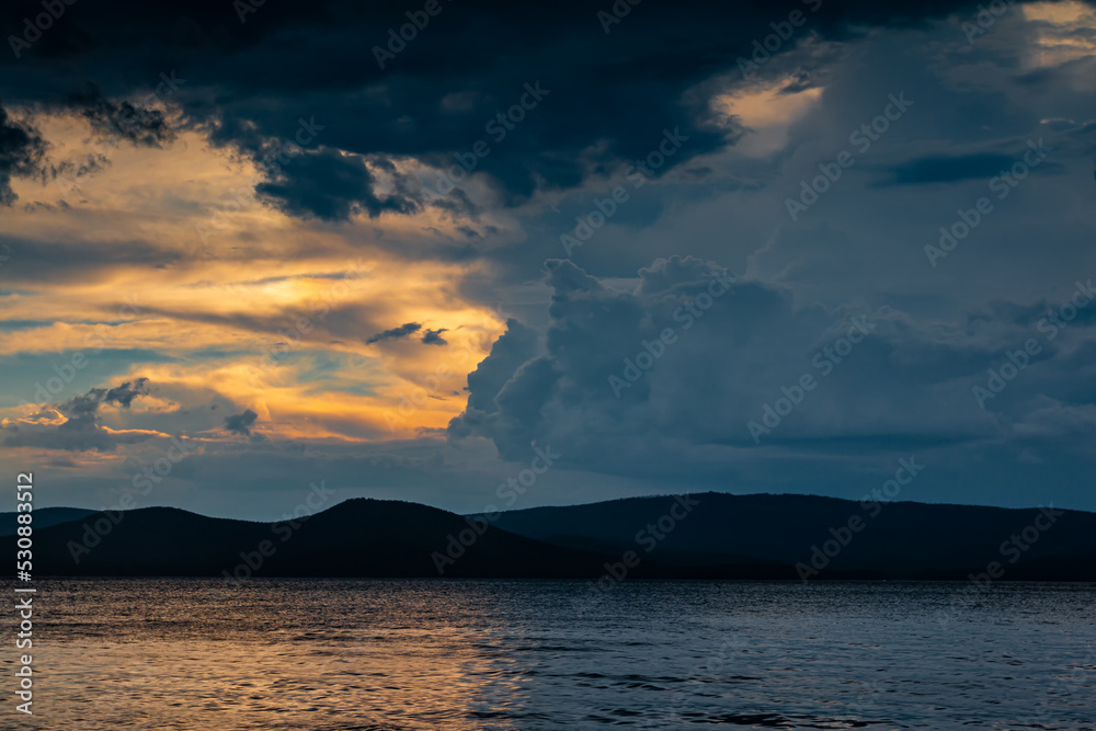 Cloudy evening before rain on a scenic lake Cloudy evening before rain on a scenic lake
