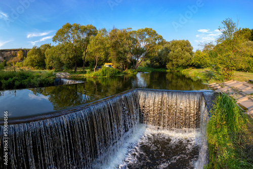 A beautiful artificial waterfall for swimming in the summer in the city of Satanov.