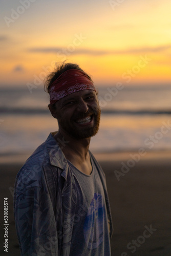 Man in a bandana on the ocean, lifestyle. © Yuliya Kirayonak