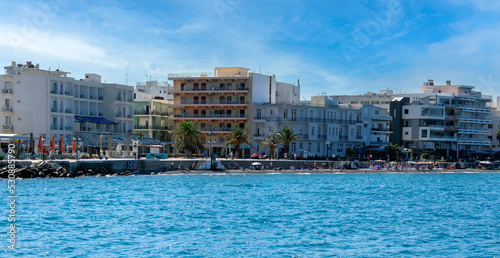 Buildings on the coastline of Loutraki, Greece. Sunny summer day with blue sky