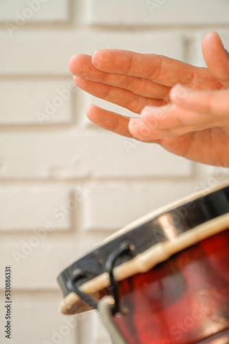 movement of hands playing the african drum. music therapy. djembe.