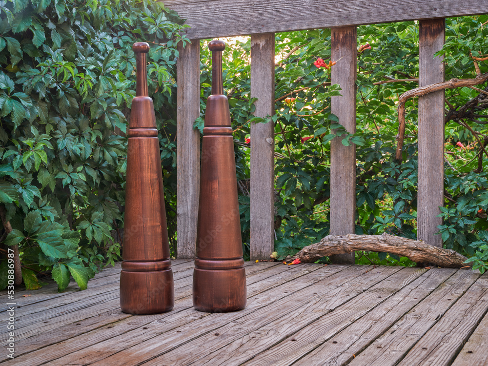 Fototapeta premium Heavy wooden Persian meels on a backyard deck, functional fitness concept