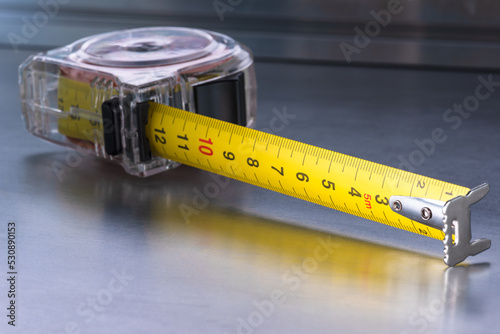 Self-retracting metal tape measure metal workshop table