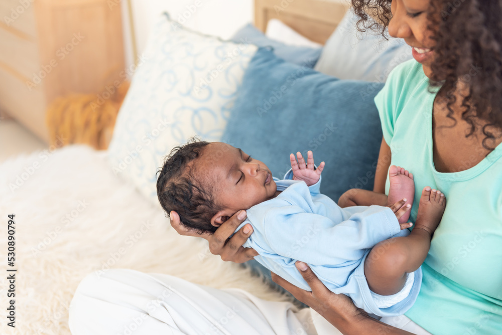 Portrait images of half Nigeria half Thai, 1-month-old baby newborn son, sleeping with his mother being held, to family and infant newborn concept. Portrait images of half Nigeria half Thai, 1-month-old baby newborn son, sleeping with his mother being held, to family and infant newborn concept.