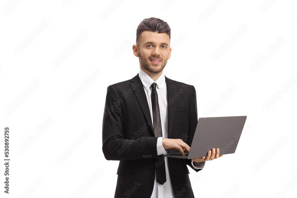 Young businessman standing and working on a laptop Young businessman standing and working on a laptop