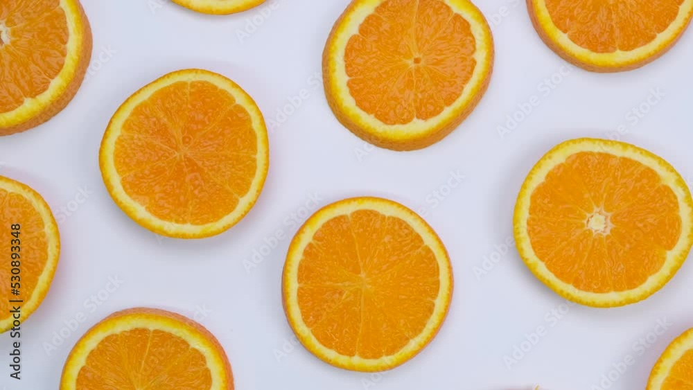 Rotating background with slides of orange on a white background, trendy summer, fruity background Rotating background with slides of orange on a white background, trendy summer, fruity background