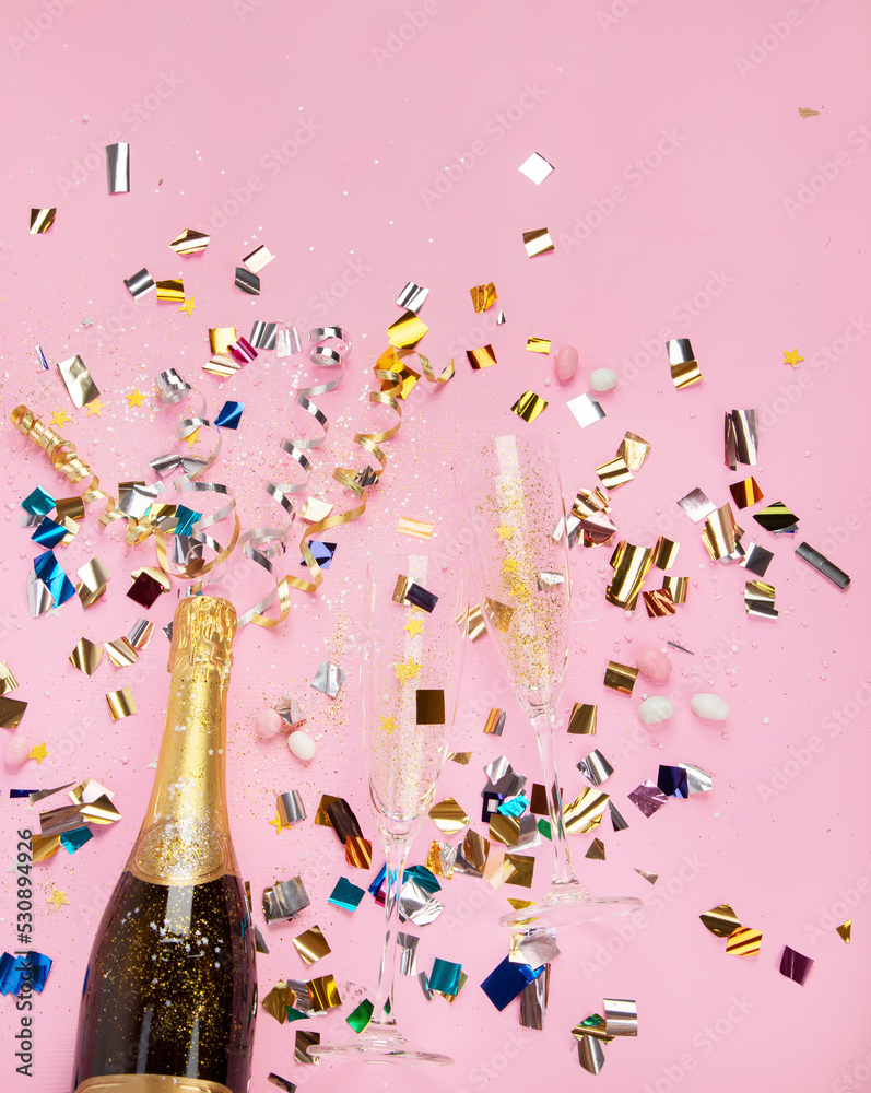 Champagne bottle with confetti on pink background. Stock Photo Adobe Stock