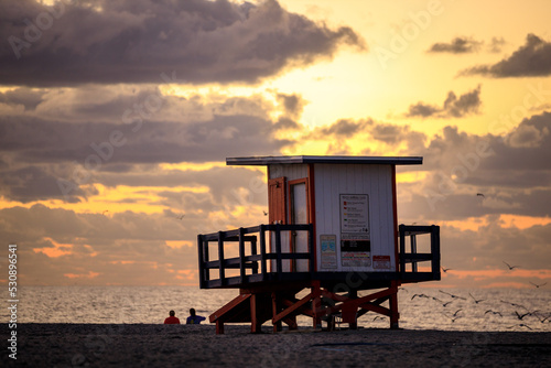 Lifeguard hut with cloudscape during sunrise at the beach