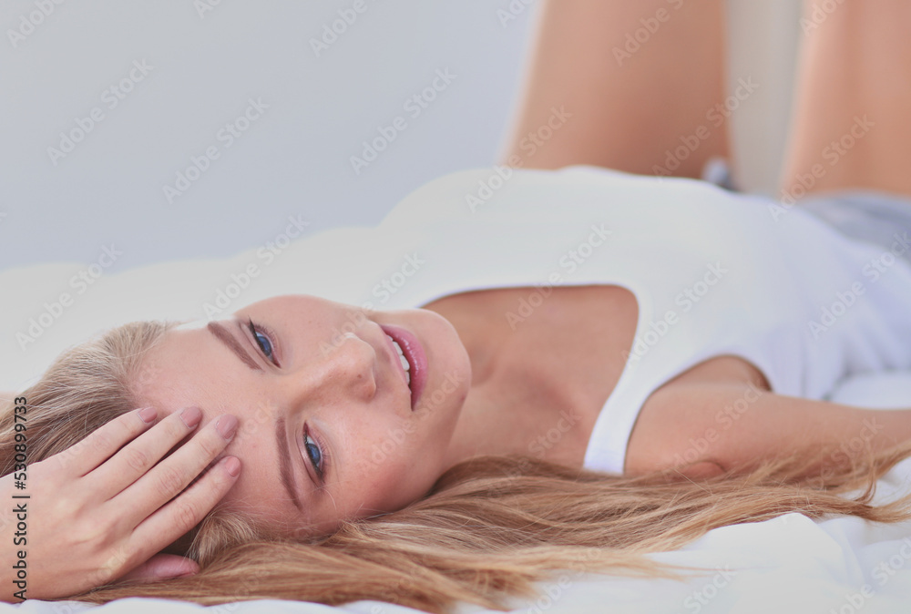 Pretty woman lying down on her bed at home . Pretty woman Pretty woman lying down on her bed at home . Pretty woman
