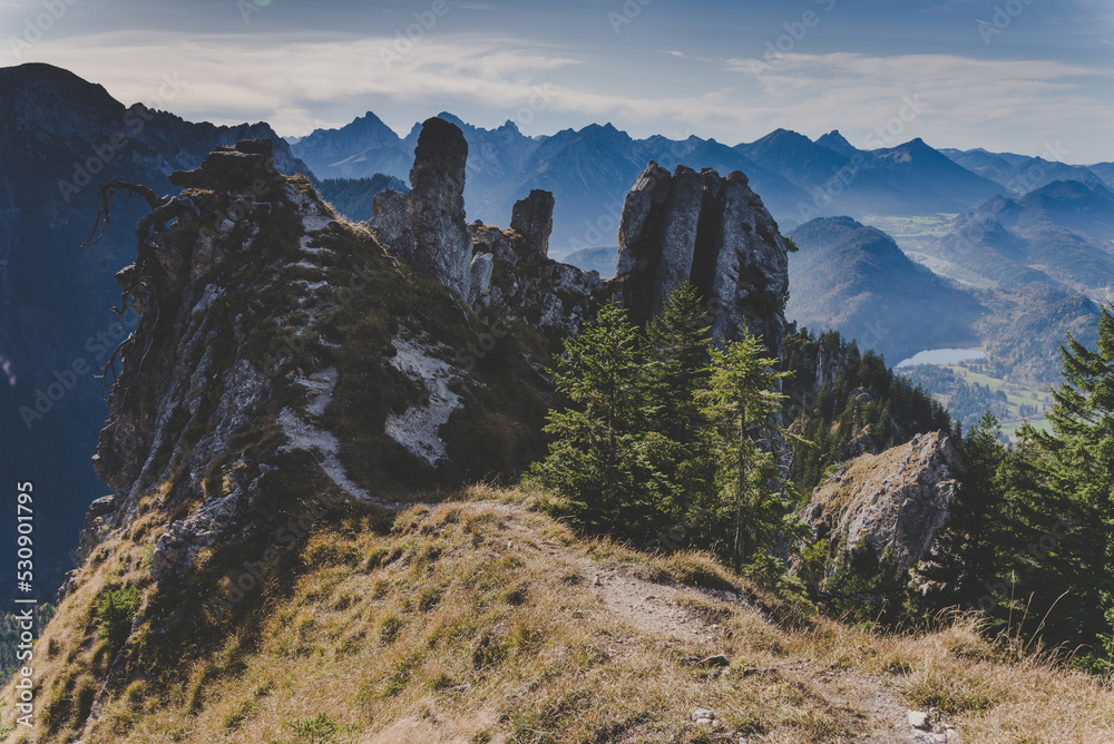 View of wild rocky mountains, high cliffs in Ammergau Alps near Schwangau. Hiking and climbing on the Tegelberg via the via ferrata at Neuschwanstein. Bavaria, Germany.