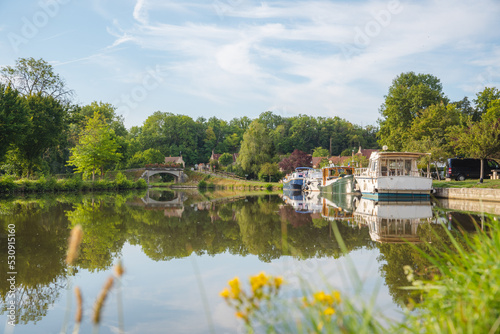 Canal near Dijon in France, with cute boats and a beautiful reflection photo