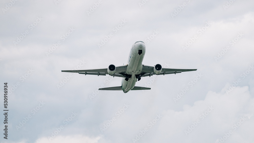 Passenger plane comes in for landing in cloudy weather. Passenger plane comes in for landing in cloudy weather.