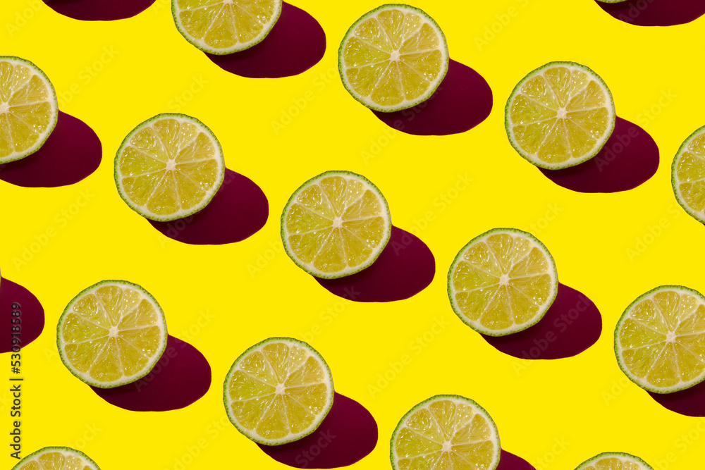 Lime pattern on a yellow background. Pop art design, creative citruses. Yellow lemon, minimal flat style.