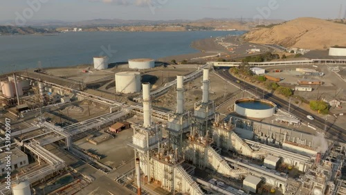 Oil Refinery Three Smoke Stacks with Water Inlet - Orbit Left to Right