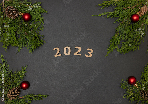 Christmas background with christmas balls and fir branches. New Year. 2023.