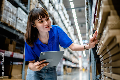 Stampa su tela Women warehouse worker using digital tablets to check the stock inventory in large warehouses, a Smart warehouse management system, supply chain and logistic network technology concept