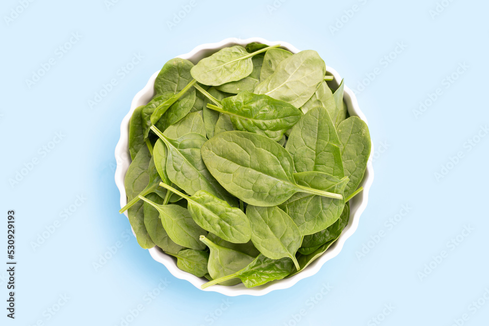 Spinach leaves on blue background. Spinach leaves on blue background.