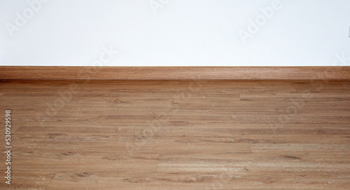 Laminate wood floor with blank white wall