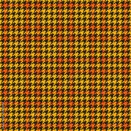 Goose foot. Halloween Pattern of crow's feet in orange, black and yellow cage. Glen plaid. Houndstooth tartan tweed. Dogs tooth. Scottish cage. Seamless fabric texture. Vector illustration