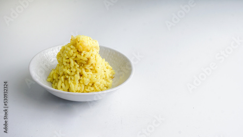 Boiled yellow rice boiled in white bowl. Isolated on a white background