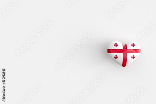 Love for Georgia - heart shaped glossy icon with national flag of Georgia. Souvenir of Georgia as a symbol of pride in their country. 3D rendering, copy space