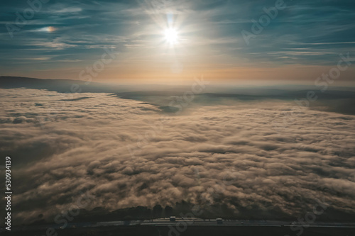 Top view of dry fields, aerial photos of fields and fog with sunset light and clouds