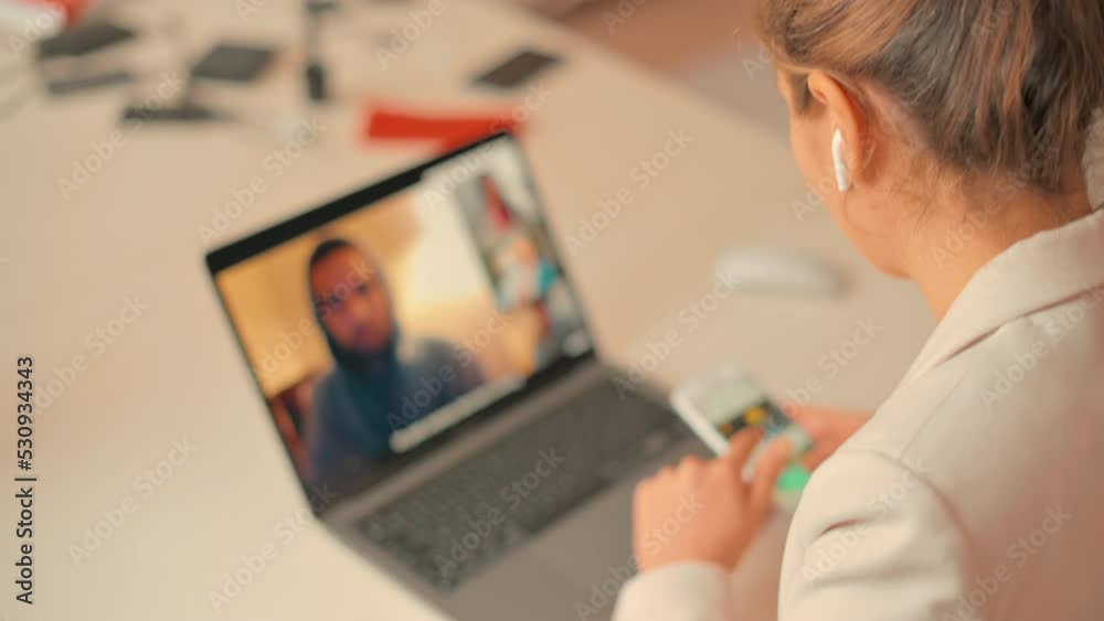 Woman working on mobile phone and notebook at home, online conference Woman working on mobile phone and notebook at home, online conference