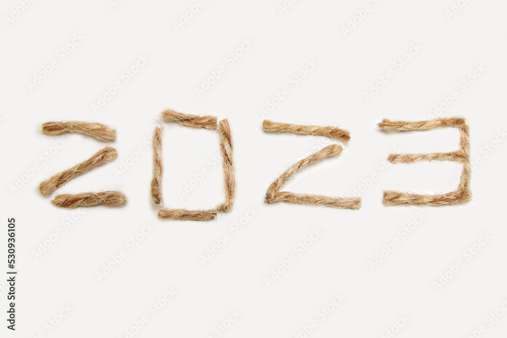 Happy New year 2023. New Year Concept welcoming New Year 2023 written by craft rope or jute on white background. Close-up. Two thousand twenty three