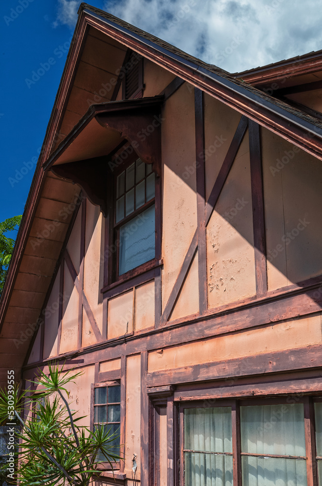 Faded Pink and Brown Chalet with peeling paint and grunge.