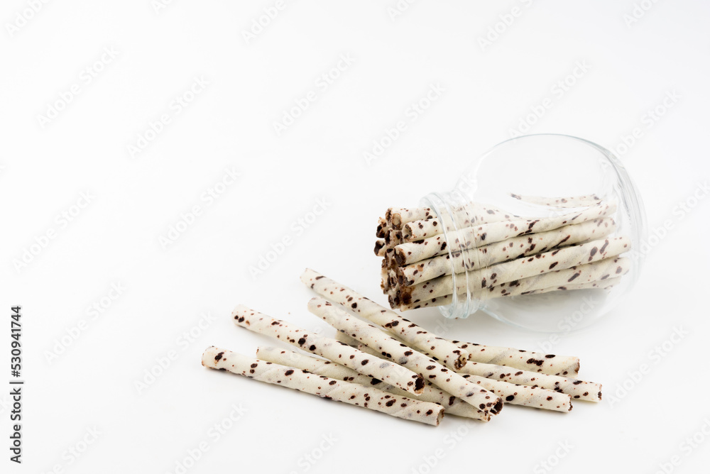 wafer rolls with chocolate in glass white background wafer rolls with chocolate in glass white background