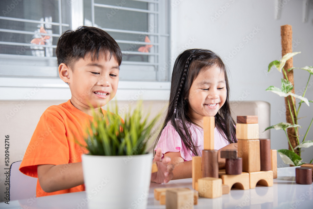 Children boy and girl playing with constructor wooden block building, Happy little kids play wood block stacking board game at home, activities learning creative, toys for preschool and kindergarten Children boy and girl playing with constructor wooden block building, Happy little kids play wood block stacking board game at home, activities learning creative, toys for preschool and kindergarten