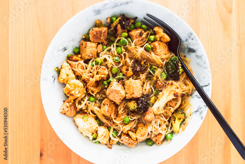 healthy plant-based food, vegan noodles stir fry with broccoli peas and marinated tofu chunks