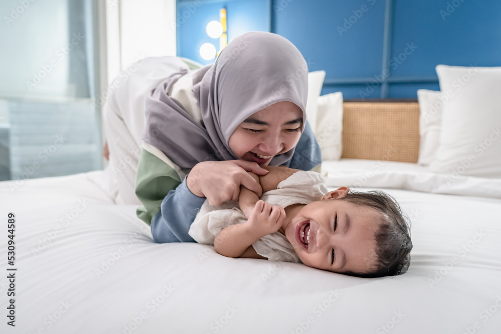 Young Asian Mother Playing and Laughing with Daughter Young Asian Mother Playing and Laughing with Daughter