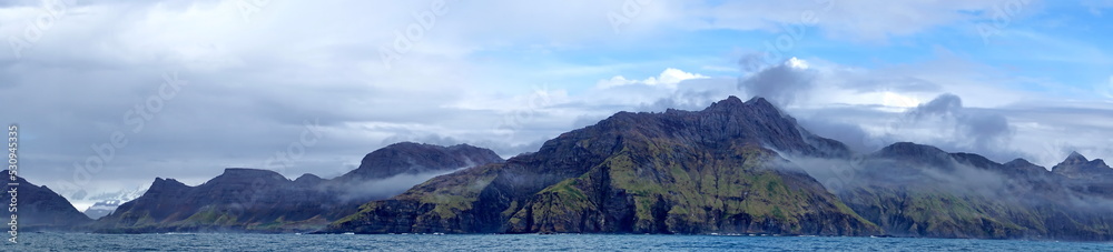 Panorama of mountains covered in lush vegetation near Jason Harbor, in South Georgia Island