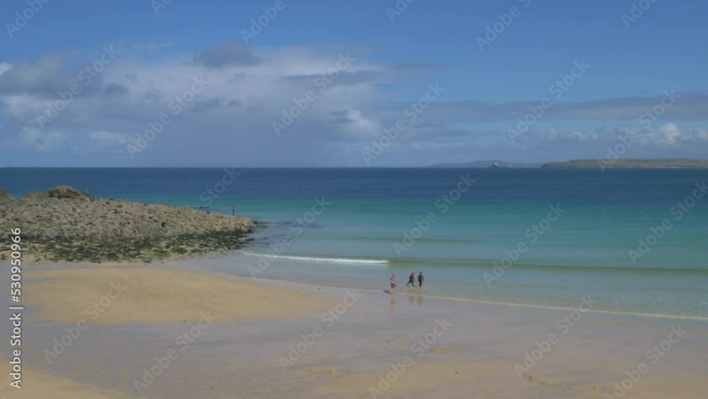Seaside view St. Ives Cornwall on sunny day isolated people in sea Seaside view St. Ives Cornwall on sunny day isolated people in sea