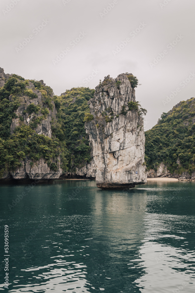 Ha Long Bay, Vietnam - March 1st, 2020 : Views on the karst mountains of Ha Long Bay on a cloudy day 