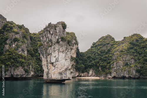 Ha Long Bay, Vietnam - March 1st, 2020 : Views on the karst mountains of Ha Long Bay on a cloudy day  © LeaGuPhoto