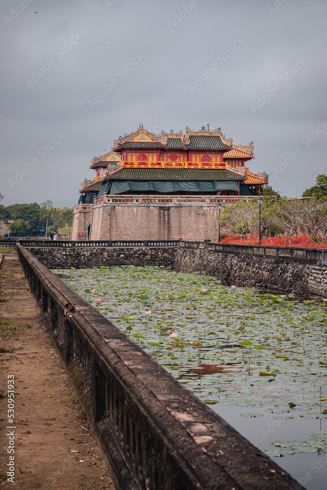 Hue, Vietnam - March 6th, 2020 : Entrance building of Hue's imperial city with the surrounding moat in the background