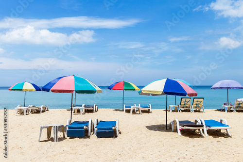 Colorful beach umbrella on tropical beach in south of Thailand  summer holiday trip to the beach  outdoor day light