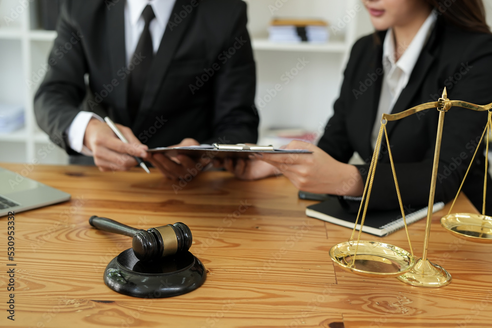 judge on wooden table And experienced lawyers meet with clients and give advice behind the scenes. legal services legal consulting concept judge on wooden table And experienced lawyers meet with clients and give advice behind the scenes. legal services legal consulting concept